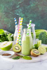 Wall Mural - A fresh and healthy green smoothie in a glass bottle, ready for drinking.