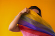 Expressive Generative AI pride photo of a lesbian woman with rainbow flag patterns. Inclusive society with equal rights. Pride day month celebration of diversity and inclusion.