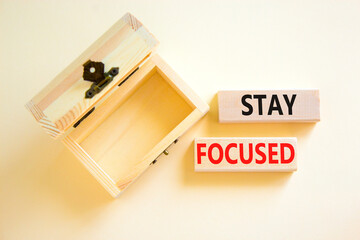 Stay focused symbol. Concept words Stay focused on wooden blocks on a beautiful white background. Empty wooden chest. Business, support, motivation, psychological and stay focused concept. Copy space.