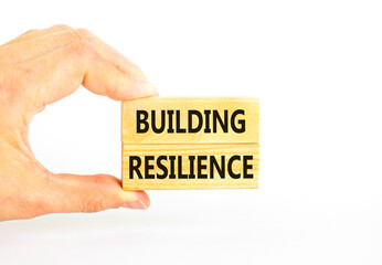 Building resilience symbol. Concept word Building resilience typed on wooden blocks. Beautiful white table white background. Businessman hand. Business and building resilience concept. Copy space.