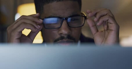 Sticker - Computer, business and black man reading, focus or working on project at night. Desktop, concentration and African male professional read email, information or report for planning deadline in office