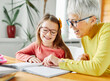 © Lumos sp - grandchild grandmother family granddaughter child teacher homework creativity home woman book notebook grandma education classroom grandparent parent daughter girl kid teaching