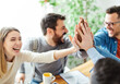 © Lumos sp - businessman businesswoman success young business team high five support unity celebrating give me five  office startup partnership diversity