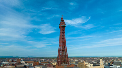 Aerial footage,of the famous Blackpool Tower and beach from the sky on a beautiful Summers day on one of Great Britains most popular holiday destinations, tourist attractions by the sea