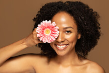 Closeup Of Cheerful Young Black Woman Posing Topless With Flower