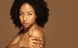 © Prostock-studio - Half-naked black lady touching her shoulder, enjoying gentle skincare routine