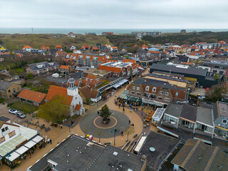 This aerial drone photo shows the city center of the small town de Koog in Texel. You can see a church and square. Texel is an island in the wadden sea, the Netherlands.