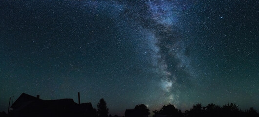 Wall Mural - night starry sky and milky way above countryside