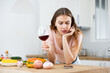 © JackF - Upset woman texting on mobile phone in home kitchen