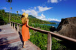 © zigres - Holidays in Ilhabela, Brazil. Full length of young tourist woman on trail in Praia Pedra do Sino tropical beach in Ilhabela, Brazil.