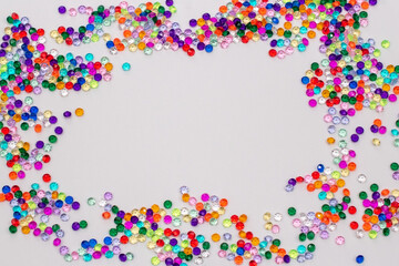 Multicolored tiny faceted crystals on a white background, beautiful colorful texture