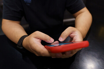 Man playing game on mobile phone. gamer boy playing video games holding Smartphone working mobile devices. cell telephone technology e-commerce concept.