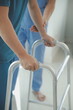 © Sirikarn Rinruesee - Physiotherapist assists her contented senior patient on folding walker. Recuperation for elderly, seniors care, nursing home.