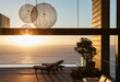 © KOTO - Patio of modern house overlooking ocean at sunset