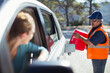 © KOTO - Woman watching roadside mechanic fill gas tank