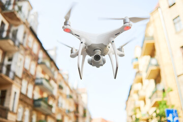 Wall Mural - drone with digital camera flying at city street