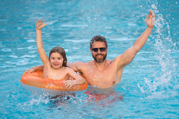 Wall Mural - Father and son swimming in pool, summer family weekeng. Father and son splash water in pool on summer family holiday. Dad and child relaxing in pool water. Child with dad swimming in pool.