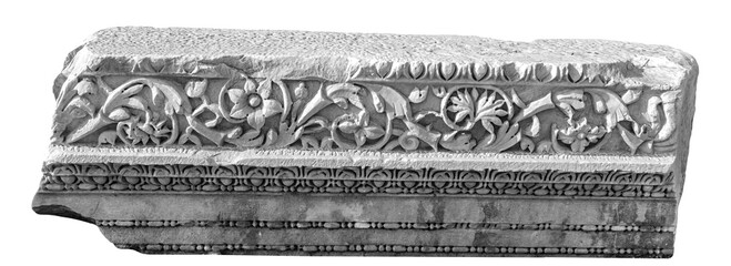 Wall Mural - Carved marble relief, fragment with floral ornament. Ancient Side city. Isolated, no background, black and white. Art, design or archeology concept. Anatolia region, Turkey (Turkiye)