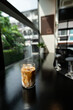 © pariwatpannium - Iced coffee in a glass on the table. Selective focus.