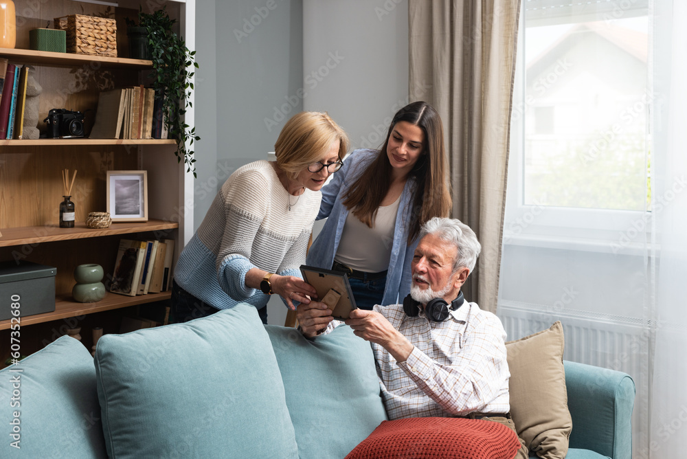 Foto Happy three-generation family hugging sit indoors enjoy time ...
