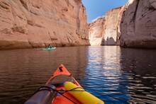 Orange Kayak Floating On Lake Powell Near Antelope Canyon In Arizona