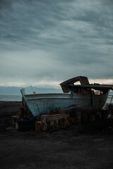  Abandoned ship on the beach with snowy mountains moody winter vertical