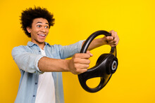 Photo Of Impressed Man Dressed Denim Shirt Hold Steering Wheel Look Empty Space At Driving Lessons Isolated On Yellow Color Background