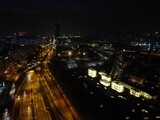 Fototapeta Miasto - Aerial shot of roads in the middle of city buildings at night in Katowice, Poland
