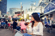 © torwaiphoto - Asian woman sitting at food festival