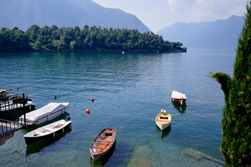 Wall Mural - Beautiful scene of boats on lake Como in Italy. A big blue lake surrounded by green hills