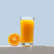 Orange juice. Glass of 100% Orange juice with orange, bottom-up view. Creative summer composition, refreshment concept.