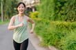 © Jirawatfoto - Fit Asian young woman jogging in park smiling happy running and enjoying a healthy outdoor lifestyle. Female jogger. Fitness runner girl in public park. healthy lifestyle and wellness being concept