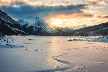 Wall Mural - Sunrise over Medicine Lake with rocky mountains and frozen lake in Jasper national park