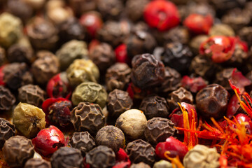 Wall Mural - Pepper spice mix and variety of spices at table background. Cooking food ingredients