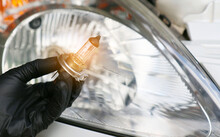 Car Mechanic Replace The Damaged Car Light Bulb And Insert The New One. ,Under The Concept Of Engine Maintenance