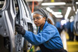 © InputUX - Confident female worker skillfully operating high-tech machinery in a modern automotive manufacturing setting, candid shot, generative ai