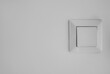 © Pixel-Shot - Modern switch on white wall in room