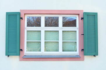 Wall Mural - view of white building with wooden window and shutters