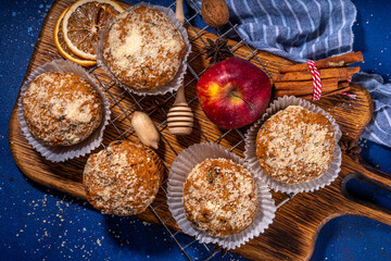 Wall Mural - Apple pie crumble streusel muffins, Sweet autumn baking pastry with red apple slices, cinnamon and spices and crumble toppings