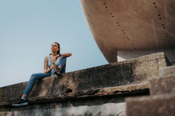 Young fitness woman resting after workout session on sunny morning.