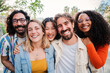© Jose Calsina - Portrait of a group of friends laughing together and looking at camera. Five young multiracial cherful people smiling and having fun. Joyful startup team coworkers celebrating and bonding together