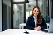 © bnenin - Portrait of a pretty businesswoman sitting at the office table in front of the laptop.