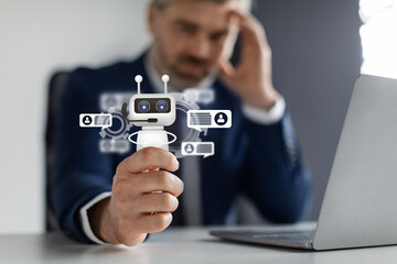 Aufkleber - Stressed businesman sitting at desk, holding robot, chat gpt concept