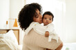 © Prostock-studio - Happy sweet black curly millennial mother with towel kissing little baby, enjoy motherhood