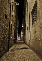 Wall Mural - Rimini, Emilia Romagna, Italy: dark narrow alley at night in the old town of the Italian city on the Adriatic sea coast