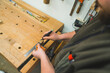 © PoppyPix - Hands of carpenter carefully drawing line using marker and ruler on wooden plank. High quality photo