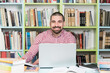 © Jale Ibrak - Happy Male Student With Laptop in Library