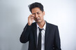 © AriaSandi - Funny asian man wearing suit crying wipes tears losing his job.