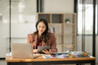 © aekachai - Asian business woman Working at the office, use notebook, smart phone
