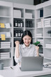 © NINENII - Asian business woman are excited business success with inspiration from their excellent financial results that are happy working in a modern office on a computer.